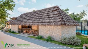 Vista exterior del restaurante de un desarrollo residencial. El edificio presenta un diseño rústico con un gran techo de palapa (paja/hoja seca) y muros revestidos de piedra apilada. Grandes ventanales de vidrio permiten ver el interior, donde se aprecian mesas y sillas de madera. Hay jardineras con plantas desérticas y agaves en el exterior, junto a un camino pavimentado. En la esquina se lee 'VITA RESIDENCIAL RESTAURANTE' con información de contacto.